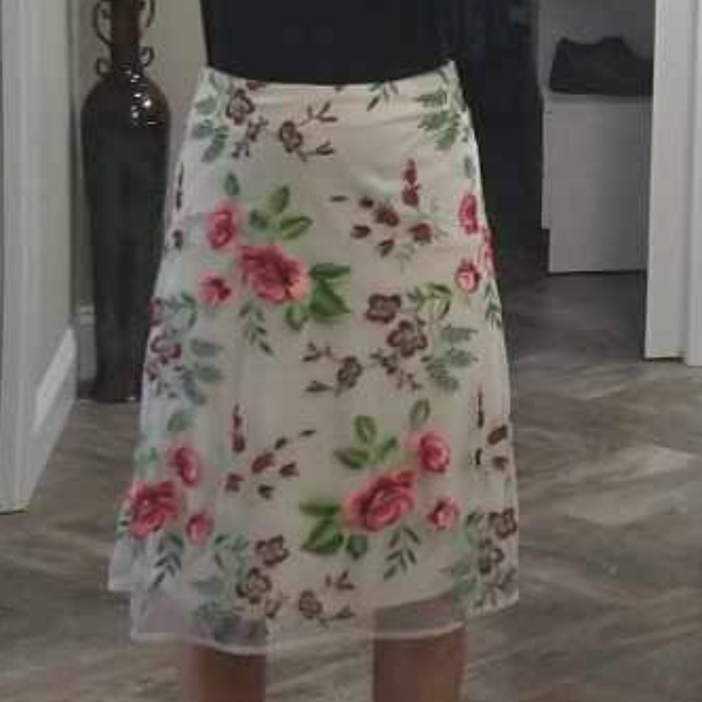 Light pink skirt with floral overlay